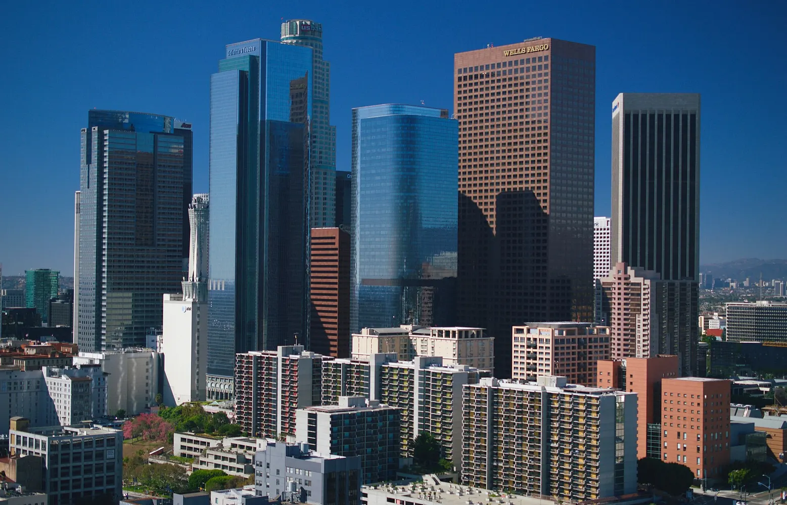 The downtown Los Angeles skyline on a clear day with office towers rising above the surrounding blocks.